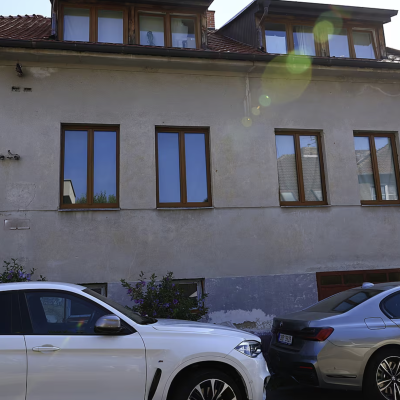 luxusní vozy BMW před domem při zatčení